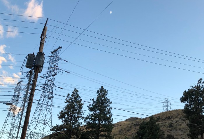 moon over hillside and power lines