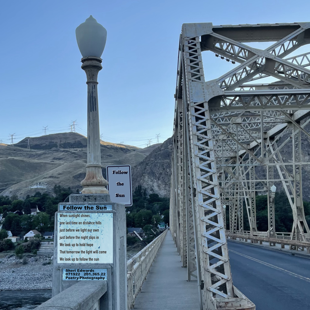 Bridge and unlit light from the 1930s with the last of sunlight on the distant hills