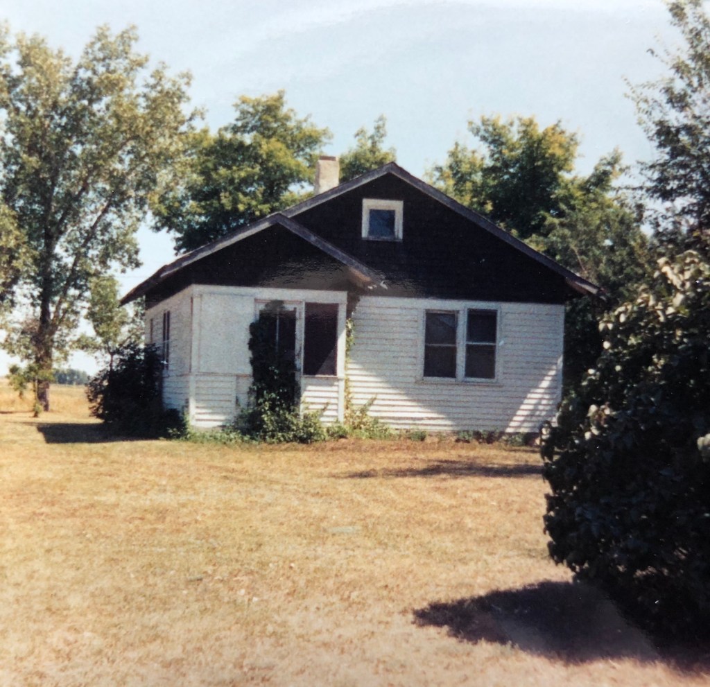 old farmhouse surrounded by dried grass